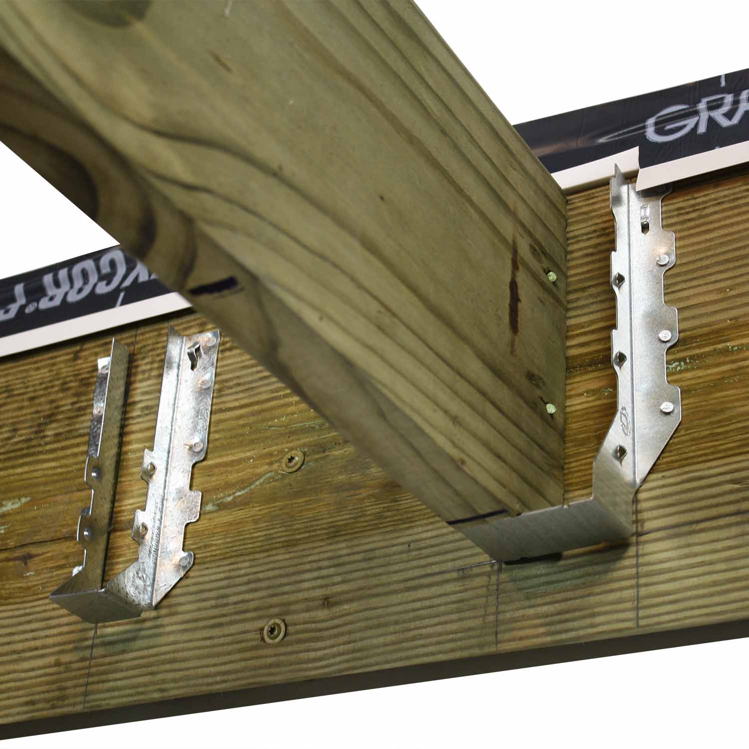 Installing treated wood joist into joist hanger on ledger